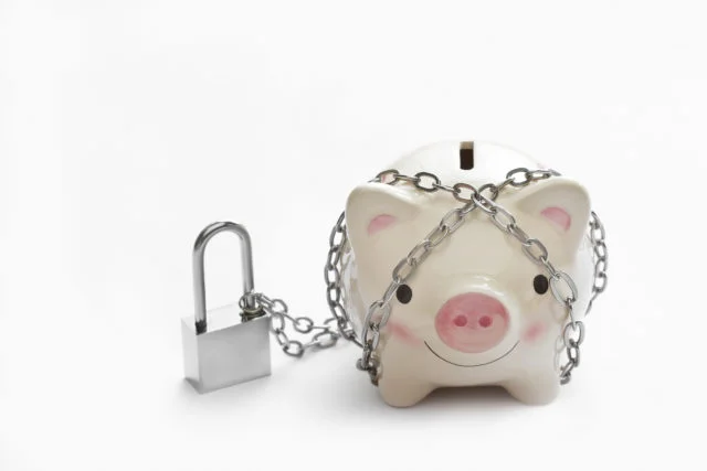 Piggy banks is lock by chain and key on white background, saving and financial concept