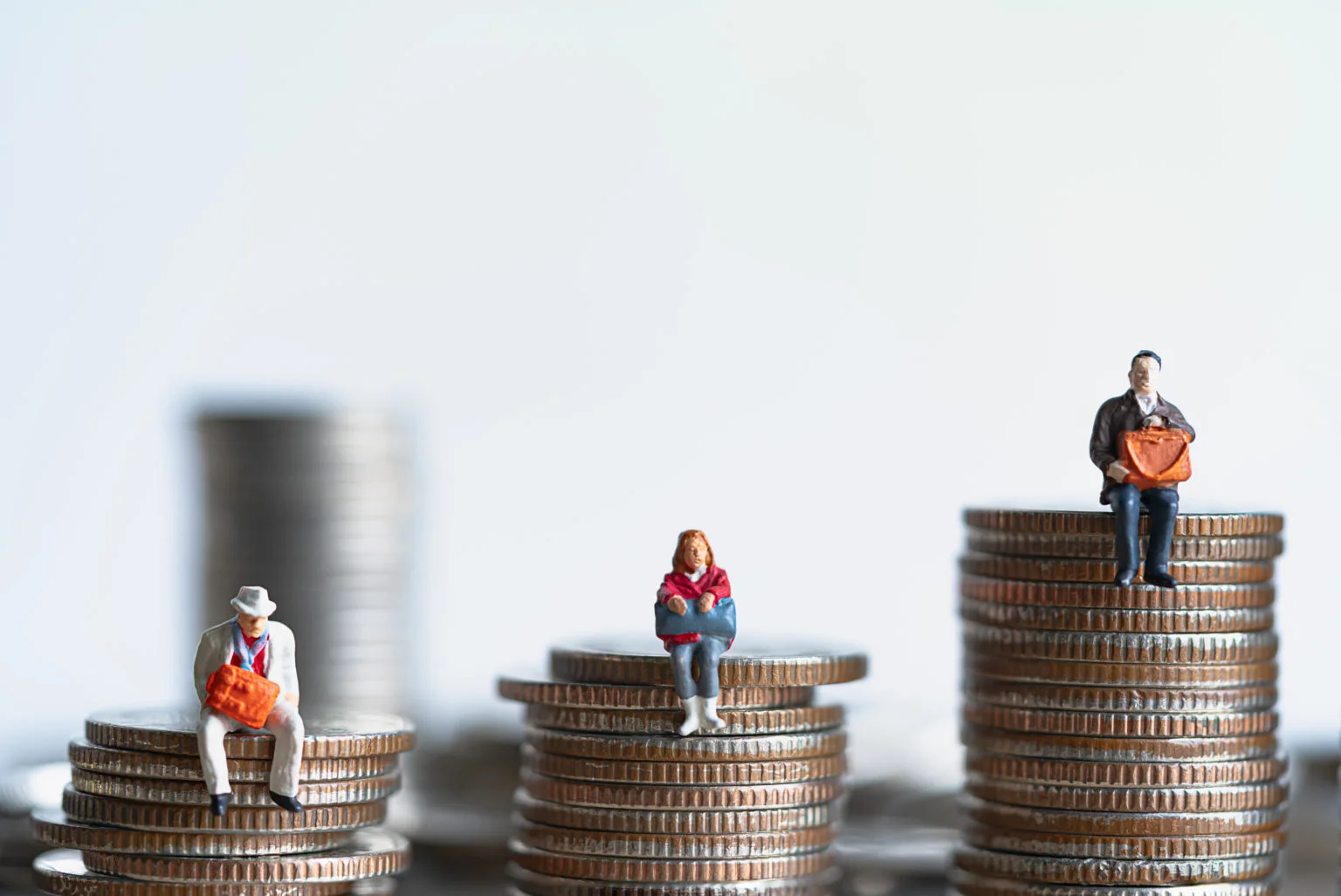 Miniature people: Elderly people sitting on coins stack. Retirem