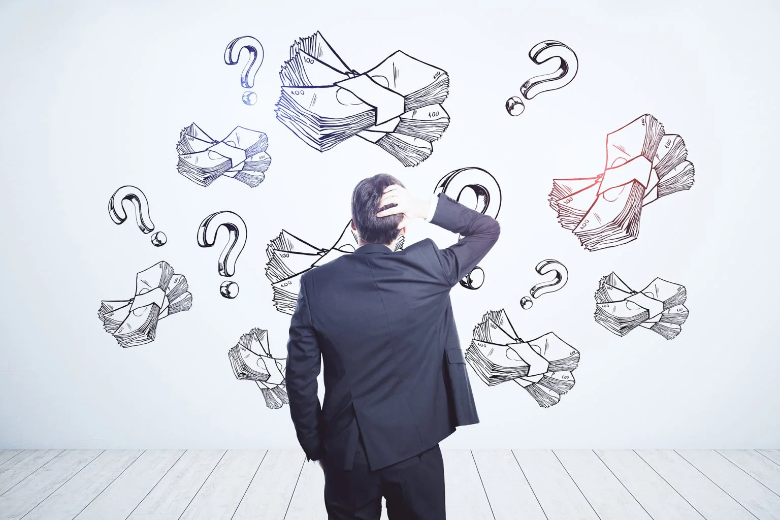 businessman looking at white wall with handwritten sketch of money packs and question marks