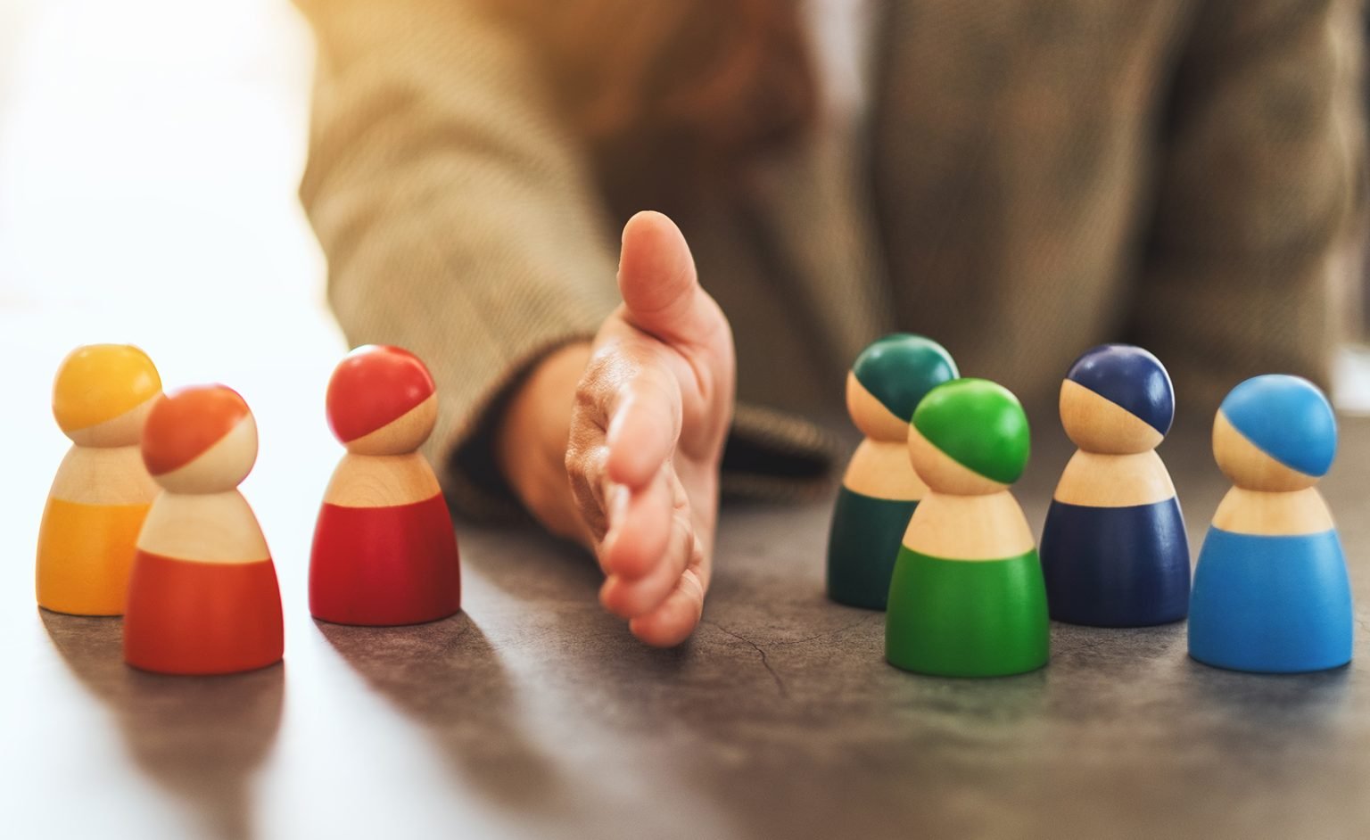 woman separate wooden people into two group