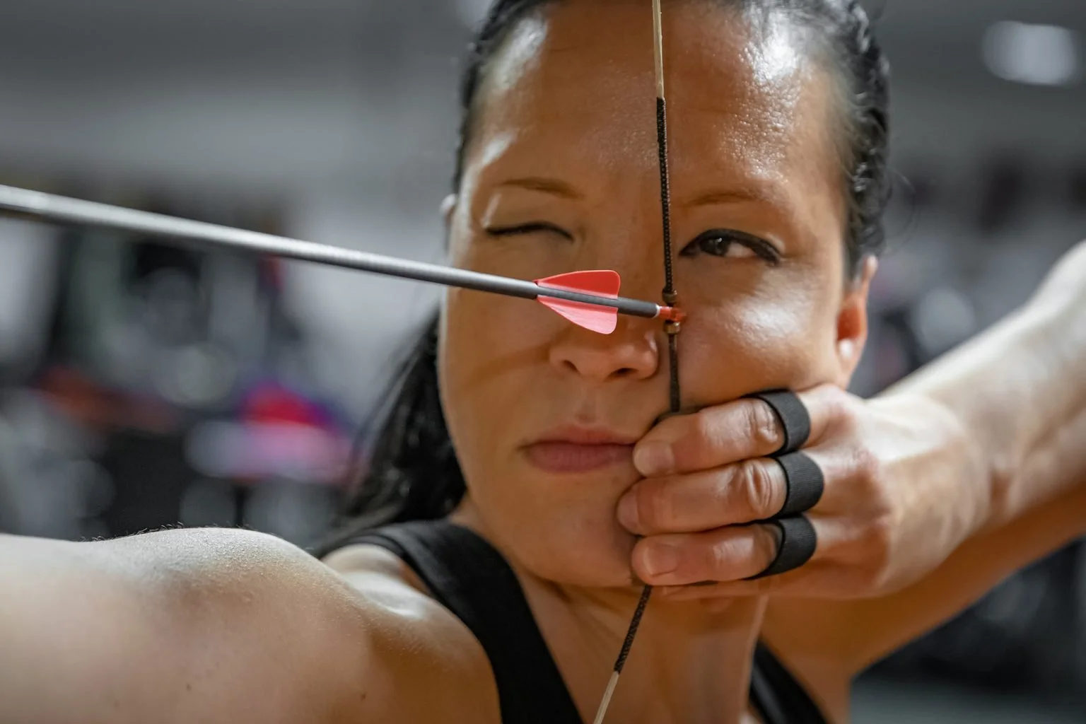 Close up of archer with bow and arrow ready to launch