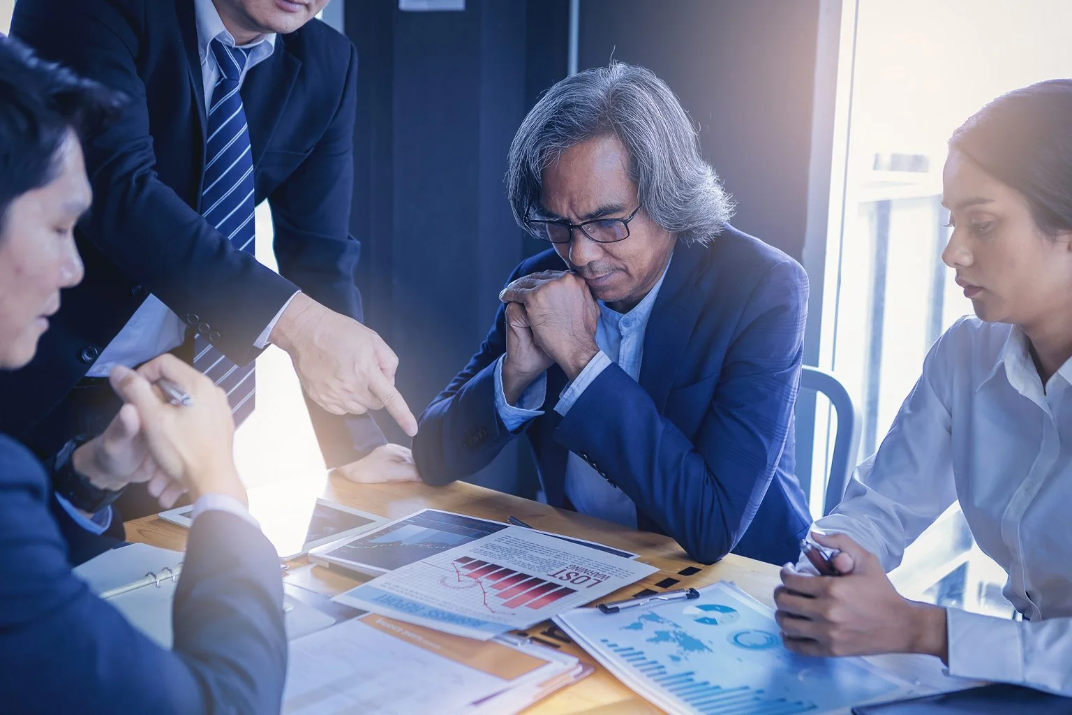 Business people meeting to analyze financial charts at a table