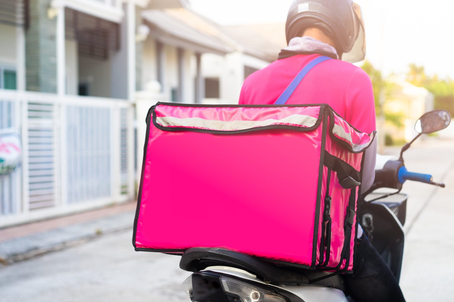 Motorbike delivery man wearing pink uniform