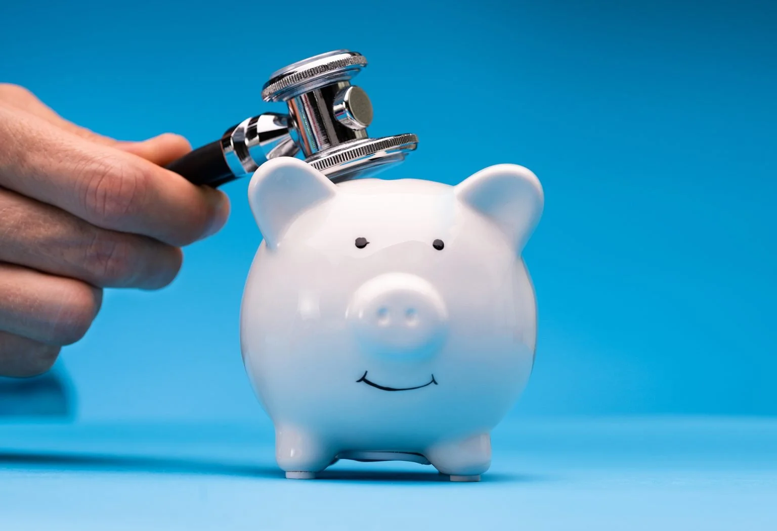 Doctor Checking Piggy Bank with a stethoscope