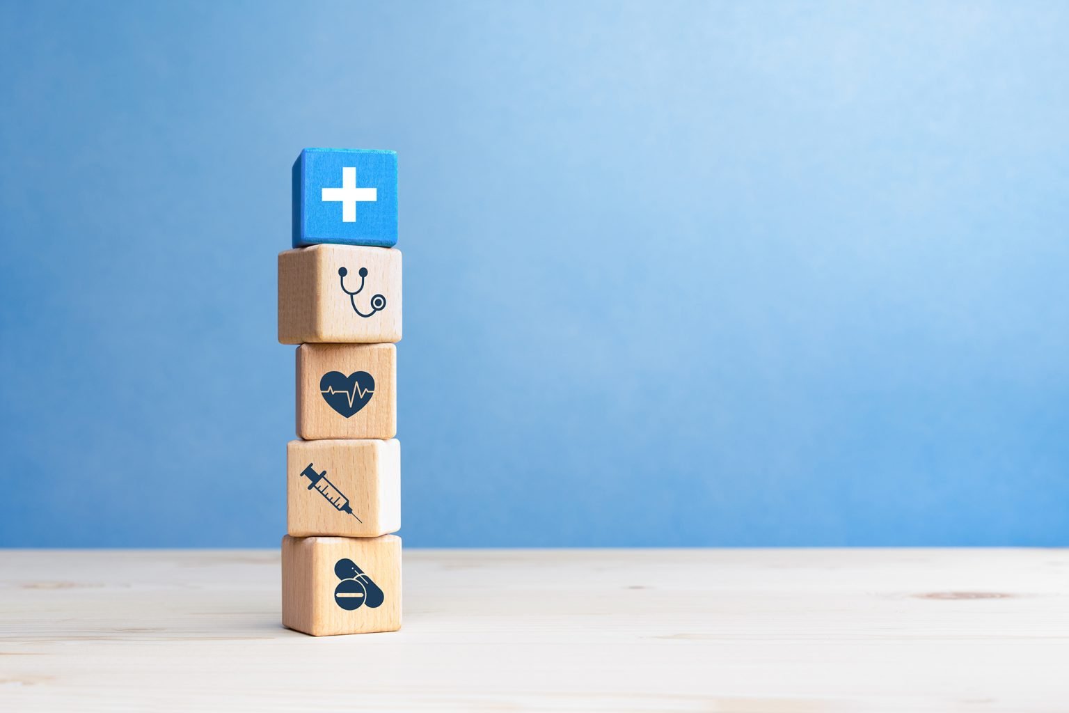 wooden blocks with healthcare medical icons on blue background