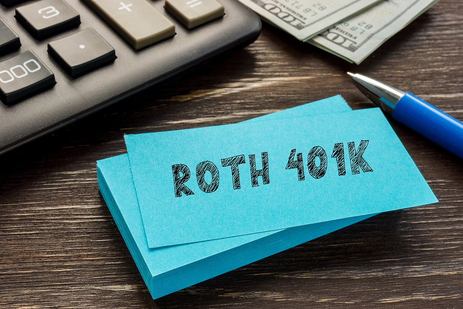 roth 401k writtein on a paper with a calculator in background