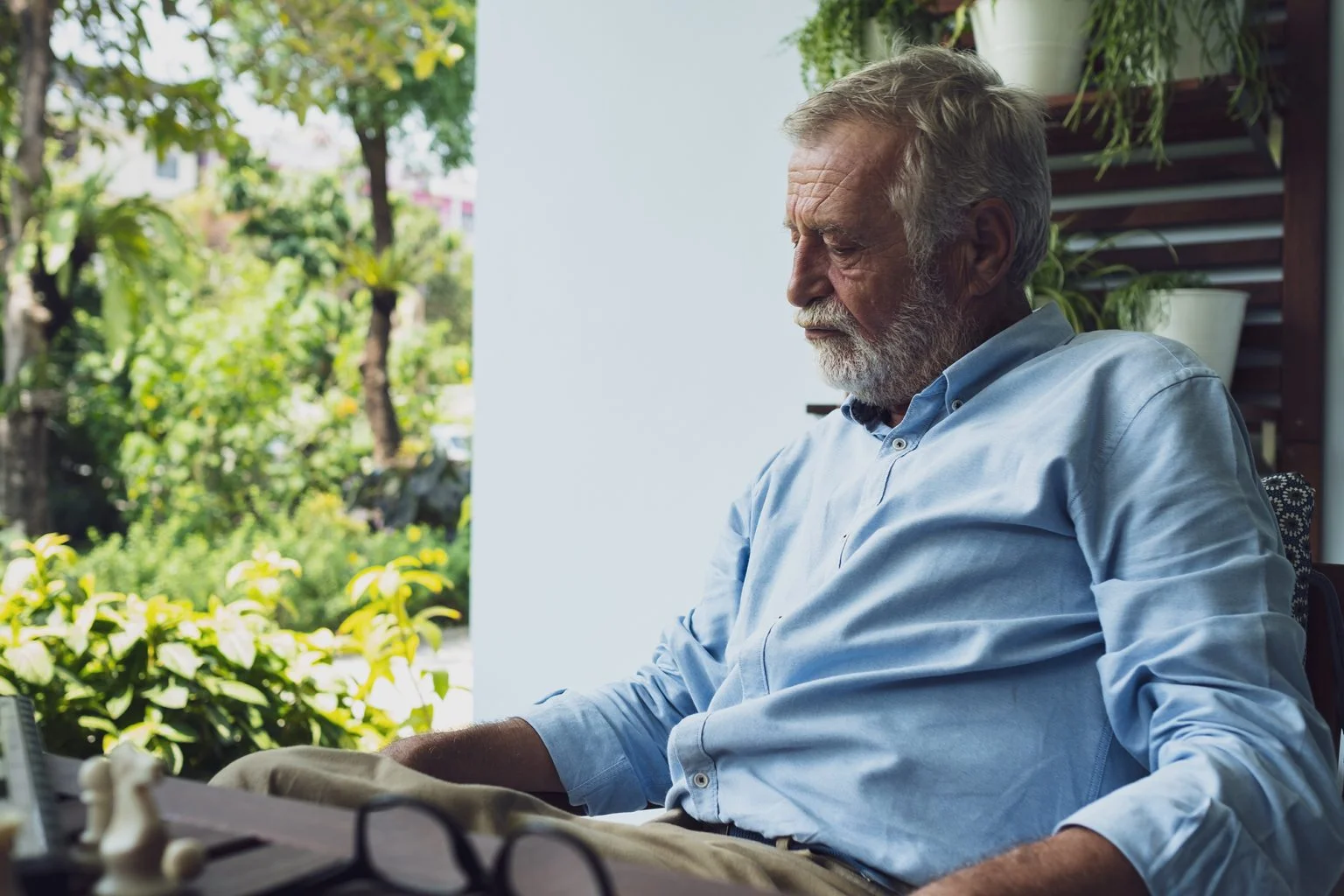 senior man thinking on a balcony