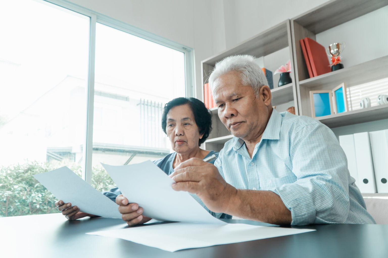 Serious senior couple looking at finances