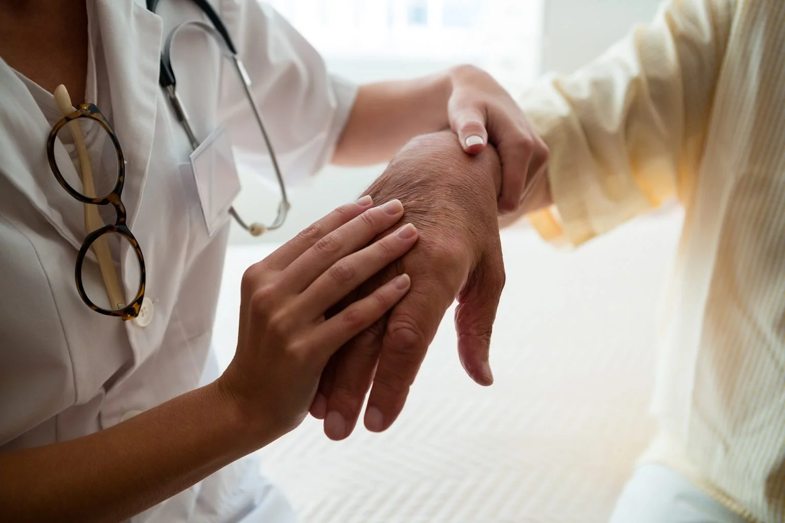 Midsection of doctor examining senior man in nursing home