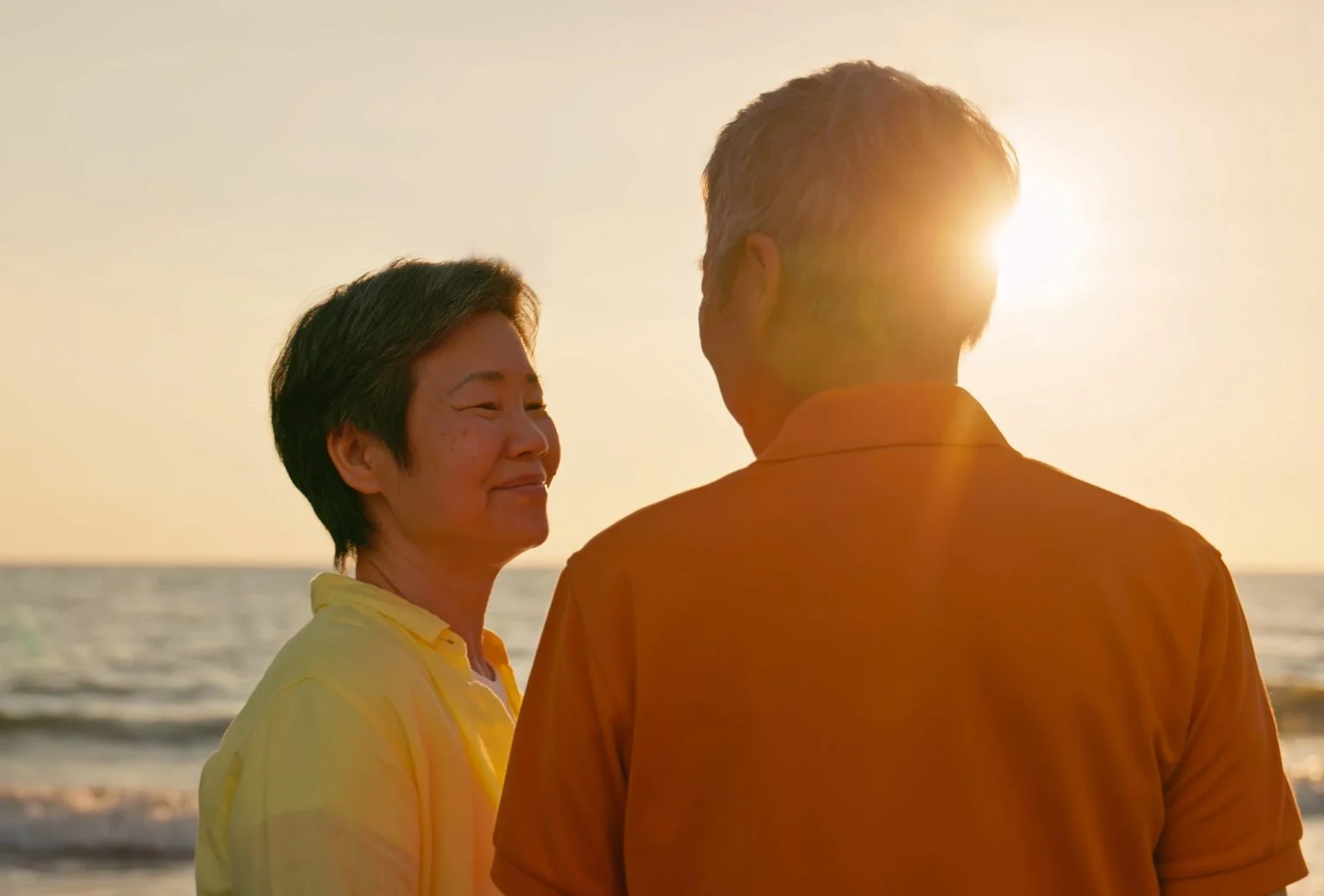 older couple smiling on the beach