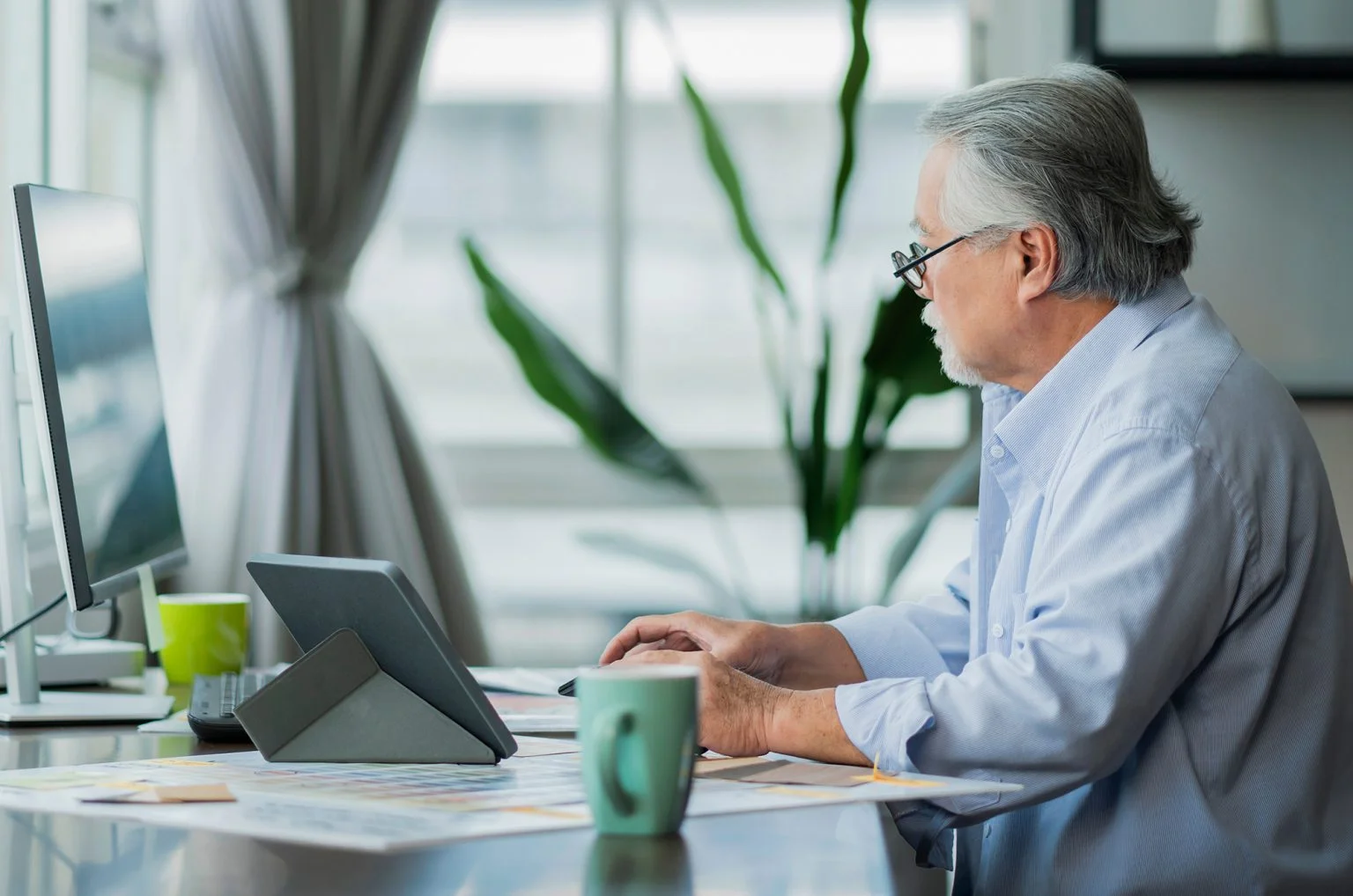 Senior man working on a computer at a desk