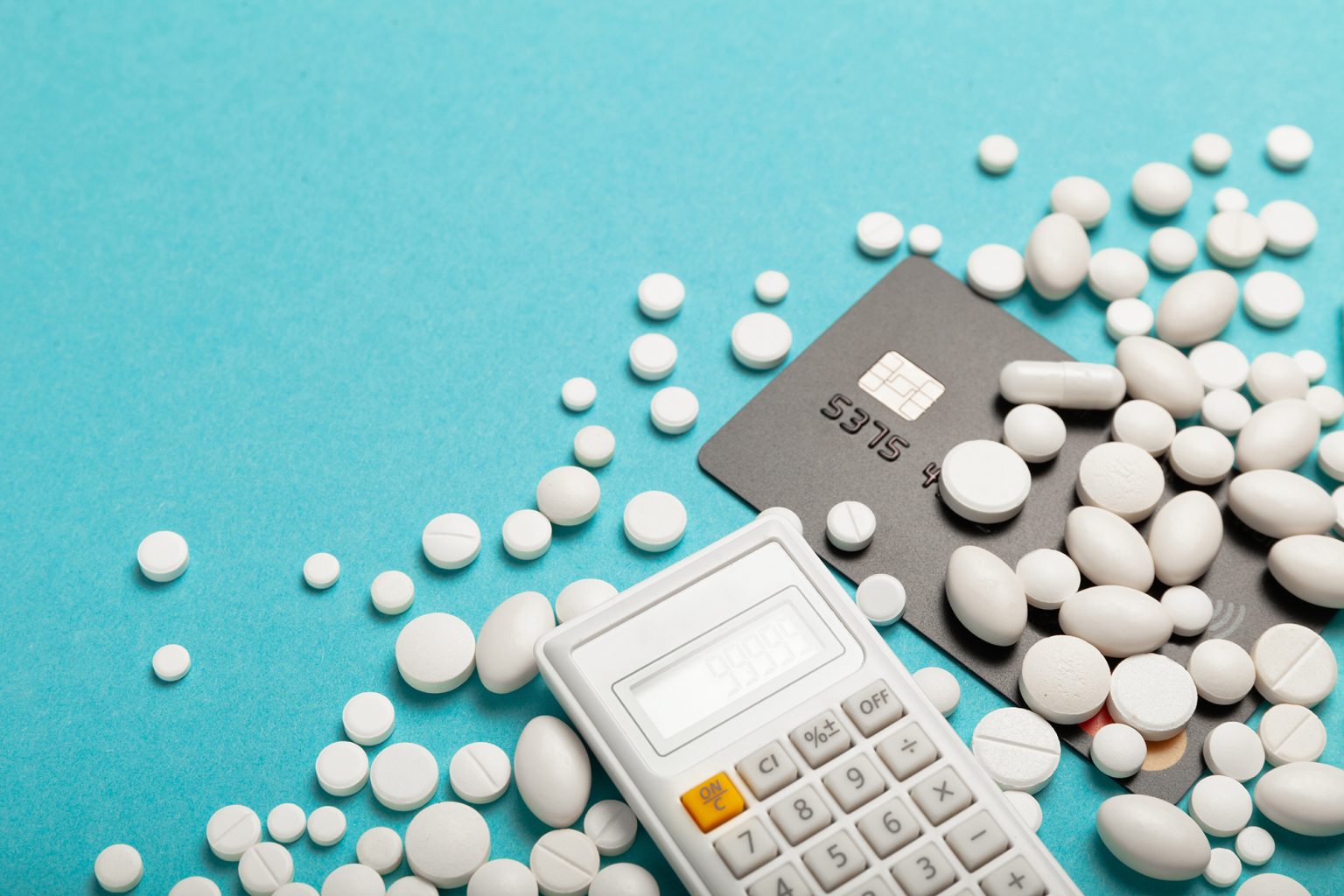 Credit card and medicines (pills) on a blue background