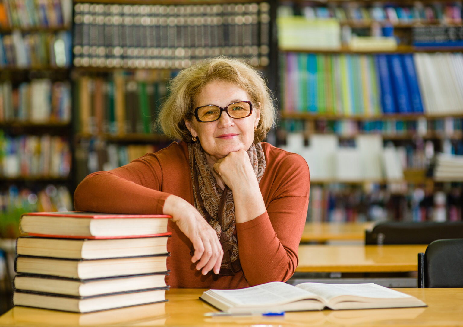 Happy senior woman in library