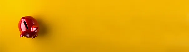 Red piggy bank on a yellow background