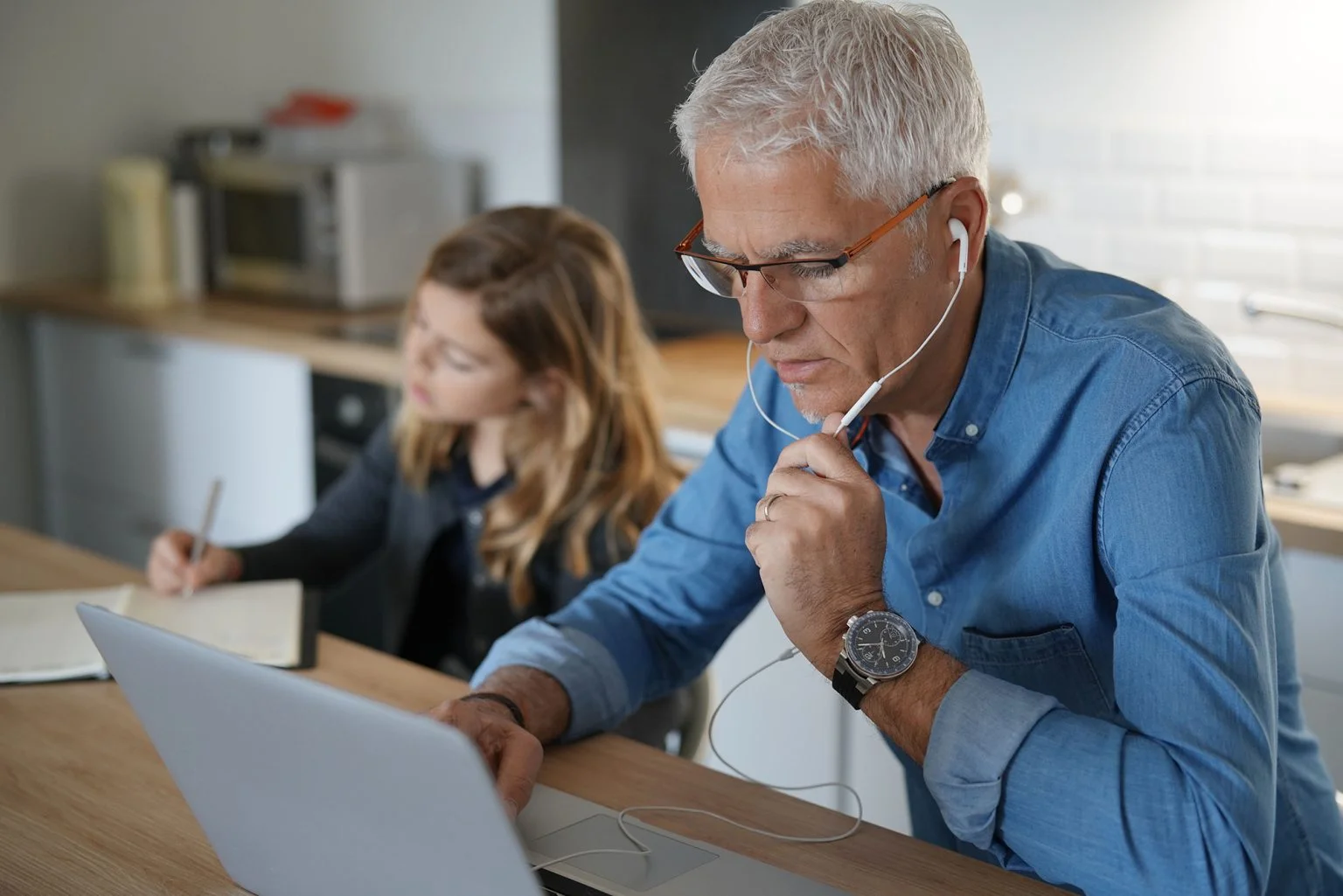 Father and school-girl working from home