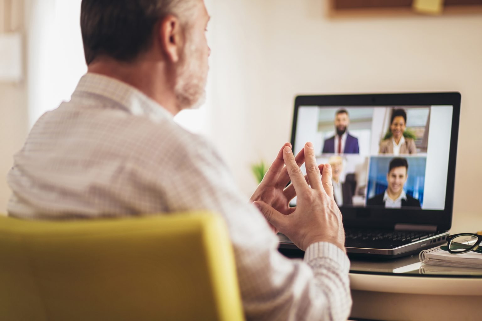 Man working from home having online group videoconference on laptop