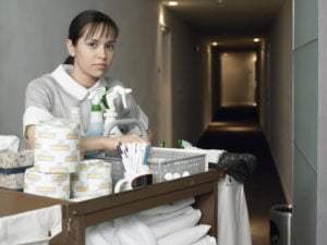 Maid in hotel corridor