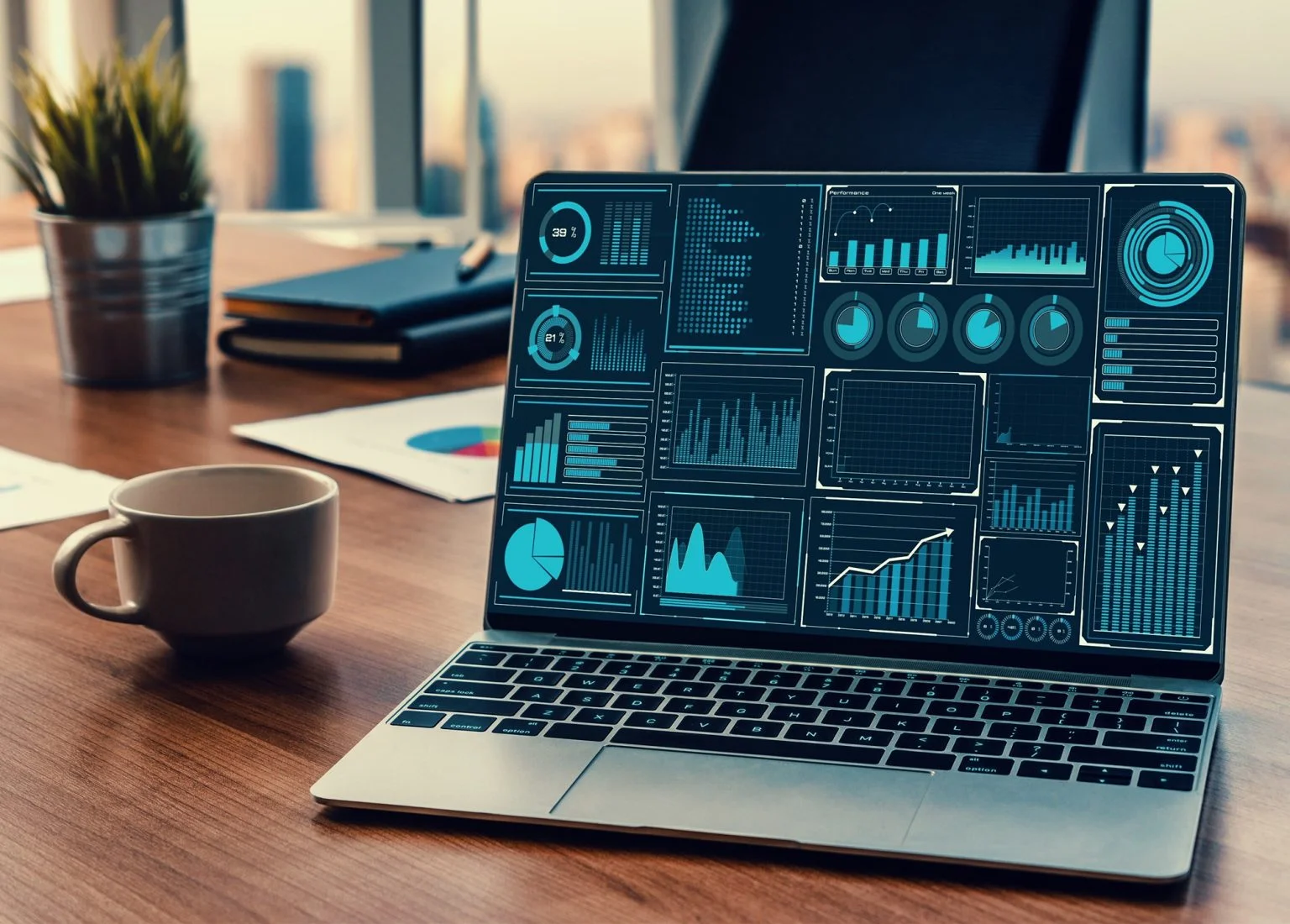 Lots of graphs on a laptop computer screen on a desk
