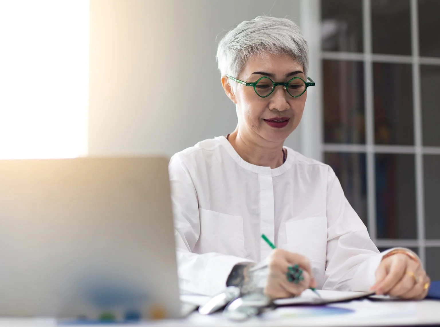 mature business woman working on laptop computer in modern home office
