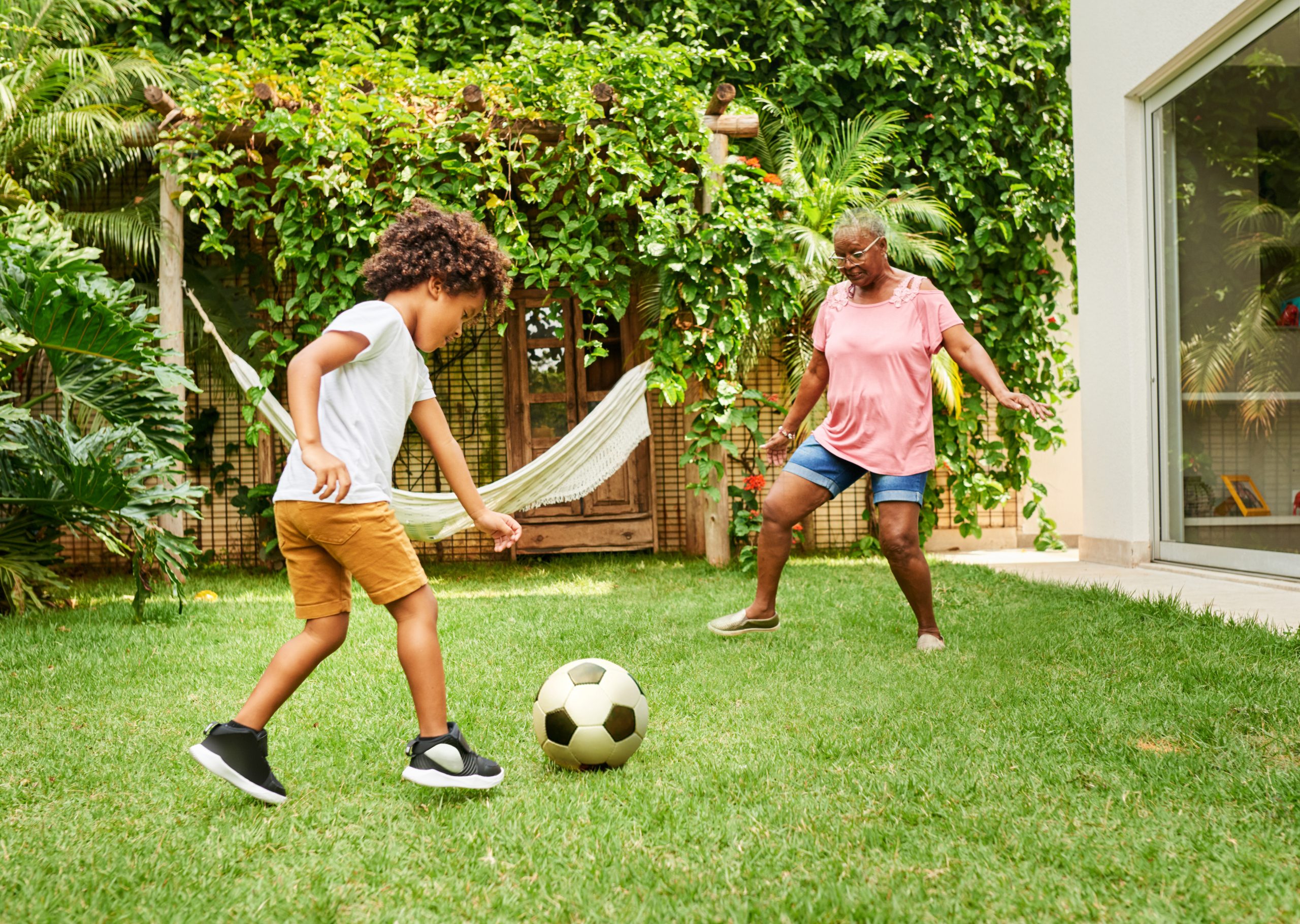 Boy and grandma playing soccer