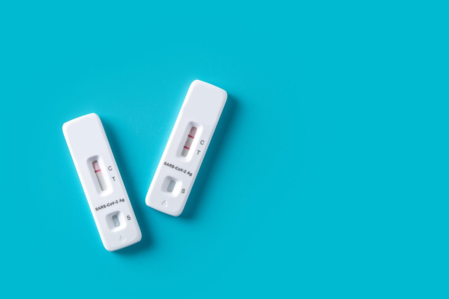 COVID-19 rapid antigen tests on a blue background