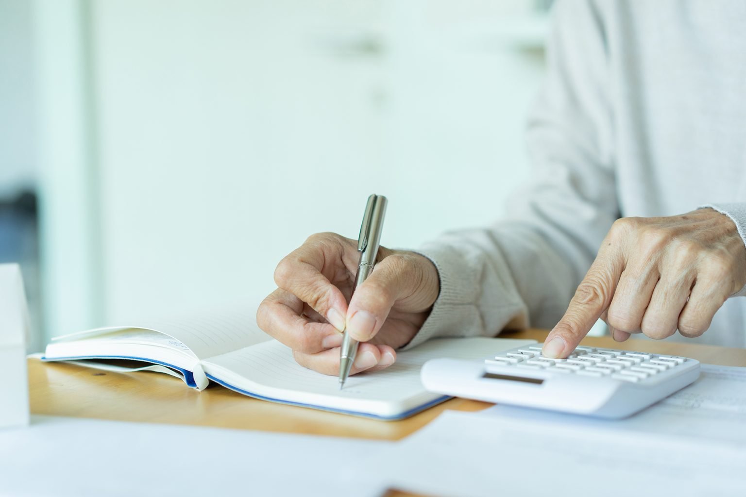 close up of older woman's hand on calculator for counting about monthly expense