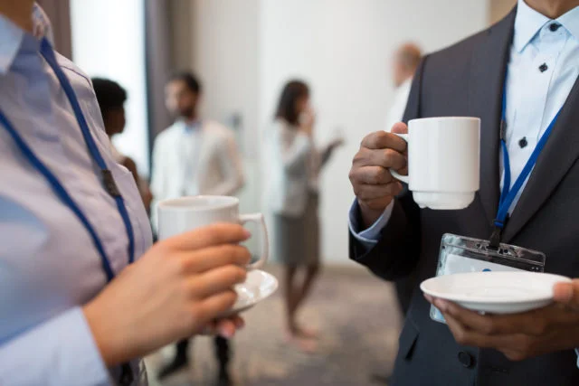 Colleagues at a conference drinking coffee