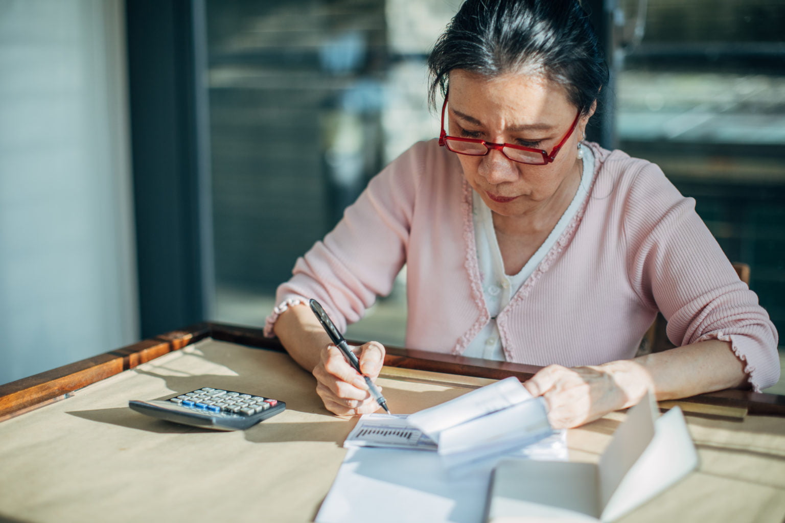 Senior woman doing finances at home