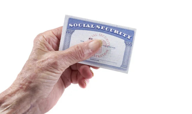 Social Security Card: Senior woman holding card in hand on white background