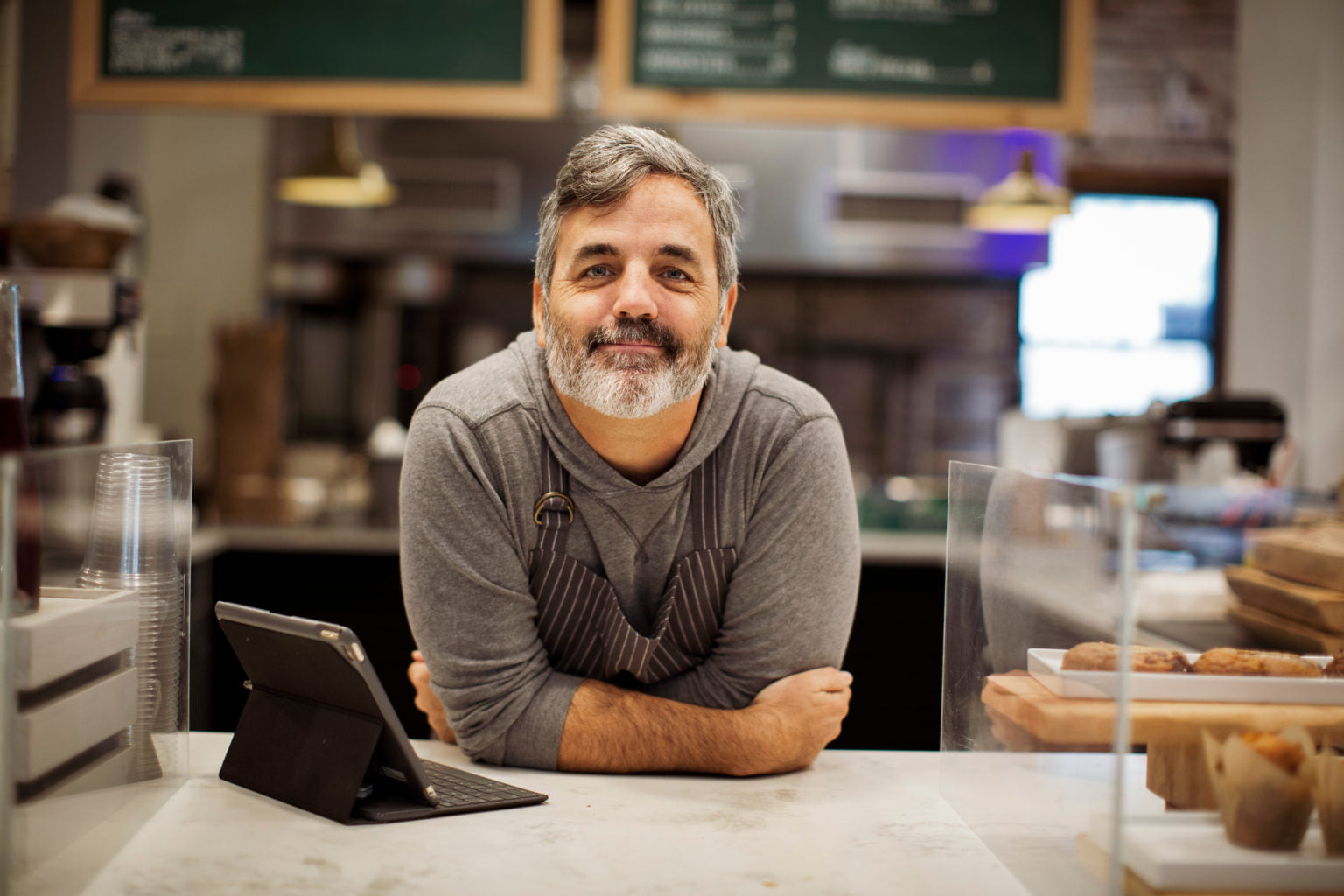 Business owner at front desk of shop