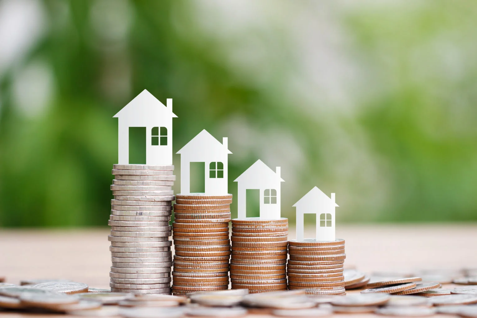 House model on coins stack for saving to buy a house