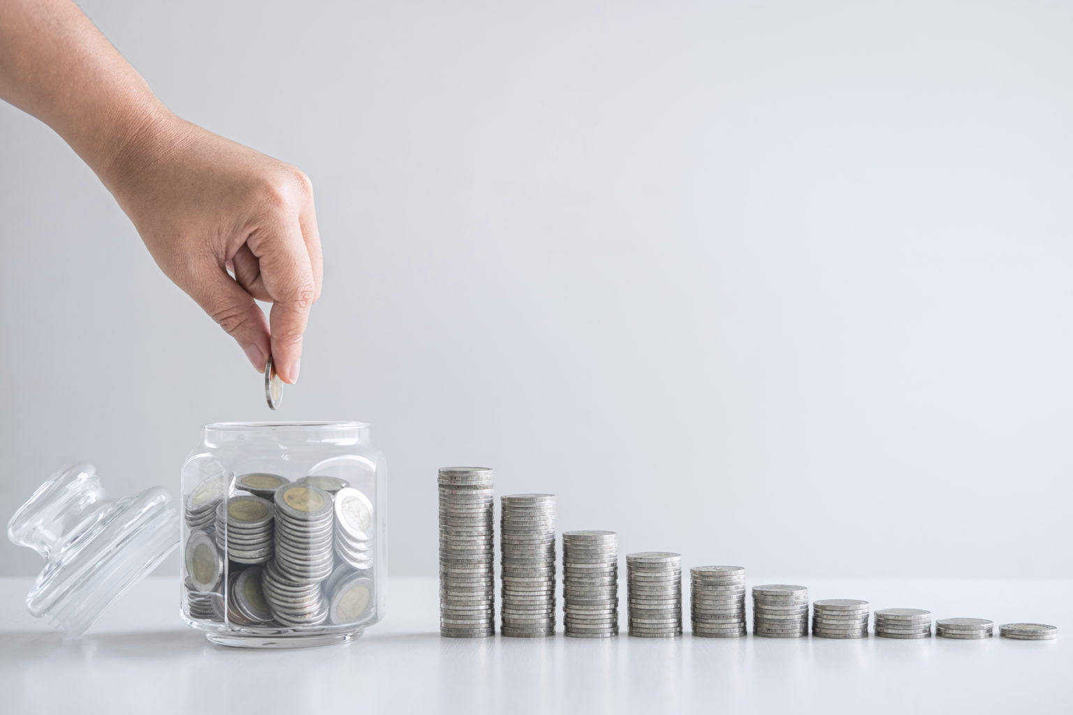 Images of growing stacking coins and Hand putting coin into glas