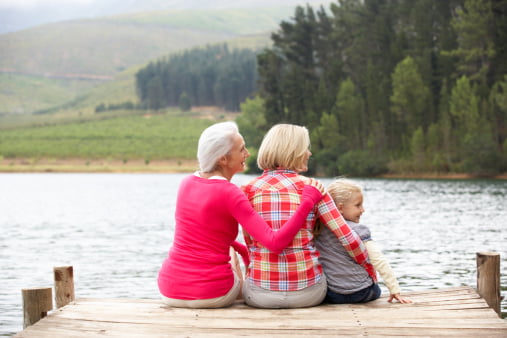 grandma mom and daughter sitting on dock