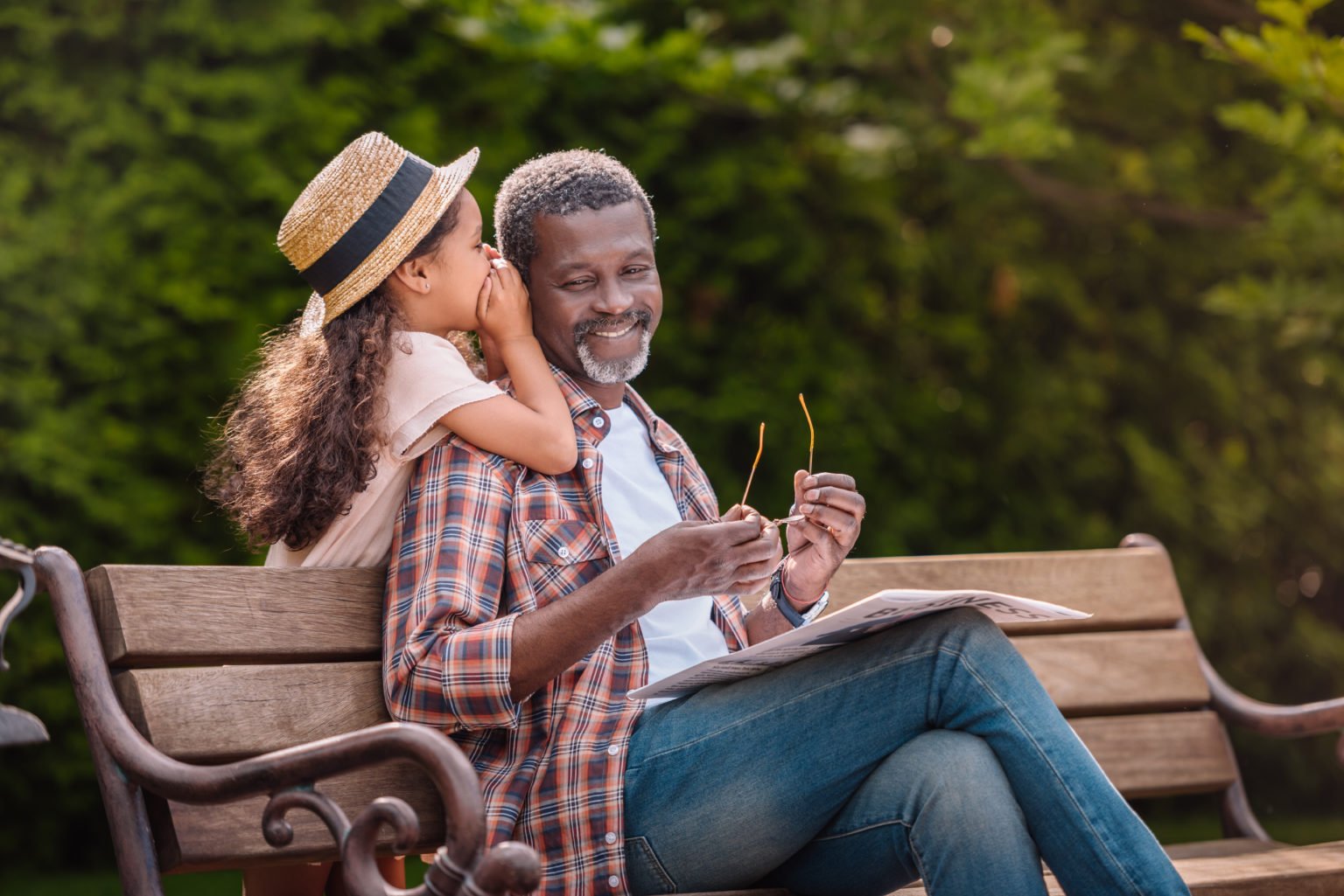 Little,Adorable,African,American,Grandchild,Whispering,To,Her,Smiling,Grandfather