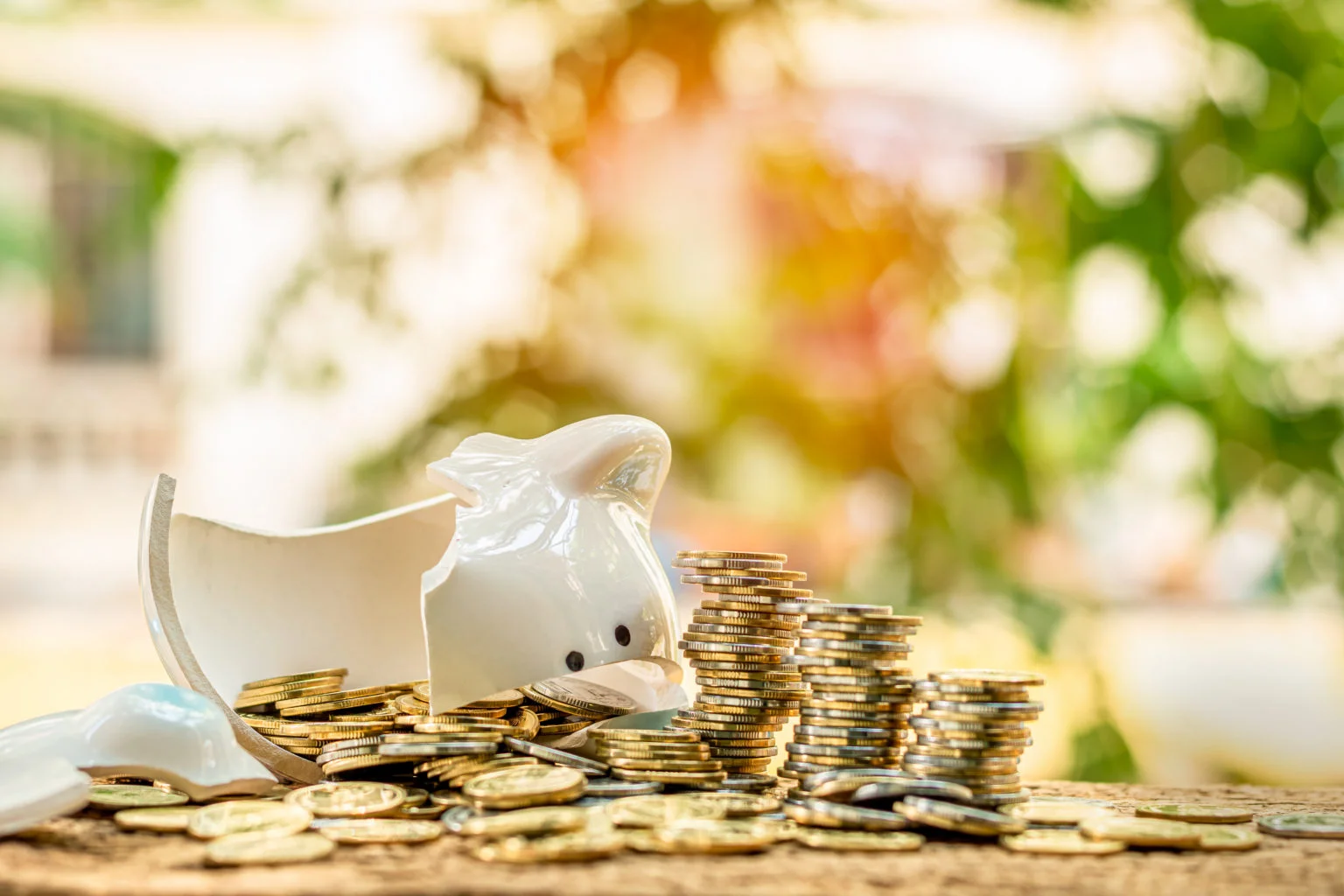 Piggy bank smashed with coins spilling out