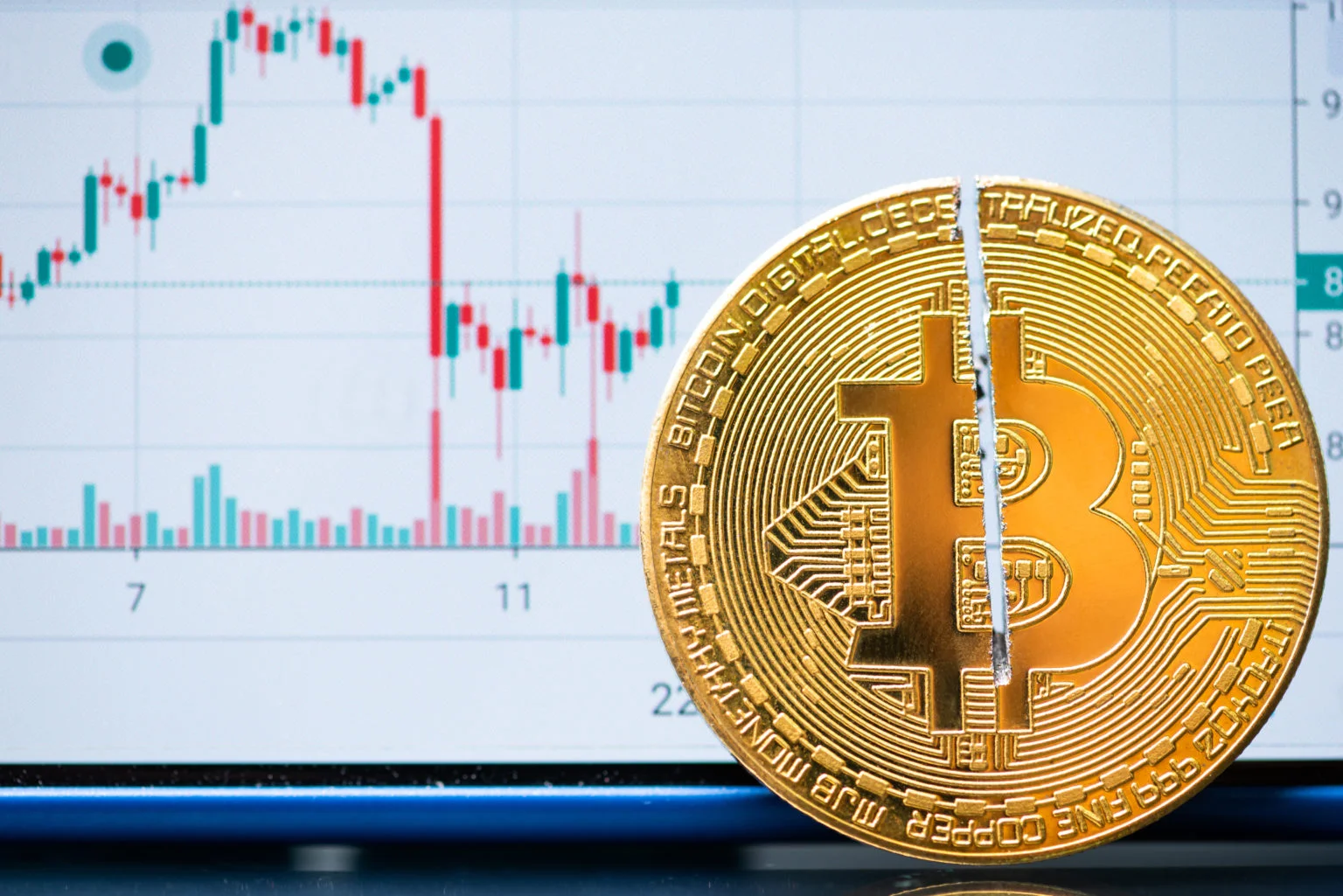 Cryptocurrency bitcoin with cutting traces in the middle on computer mainboard