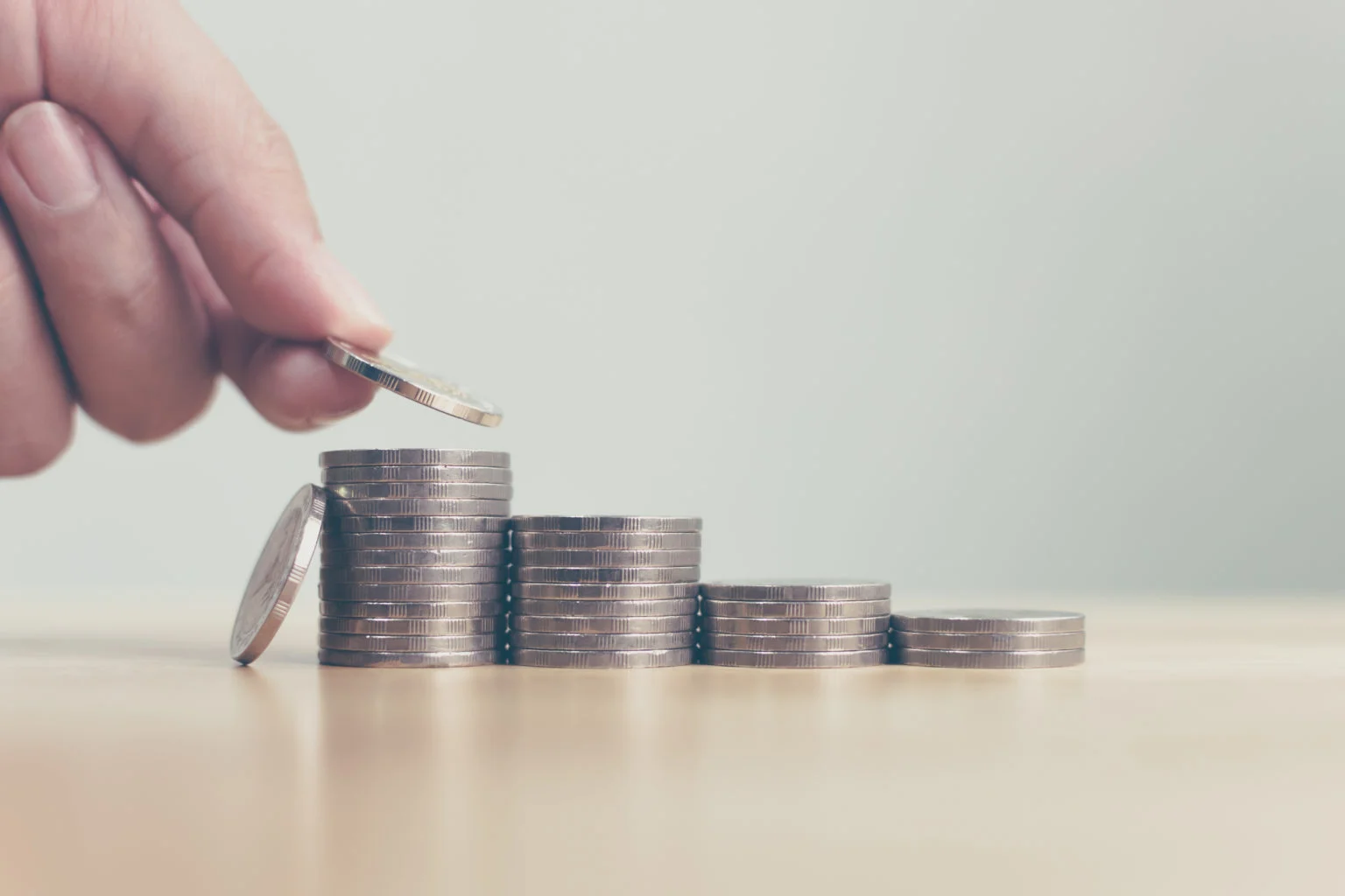 Hand putting coins stack step growing growth value