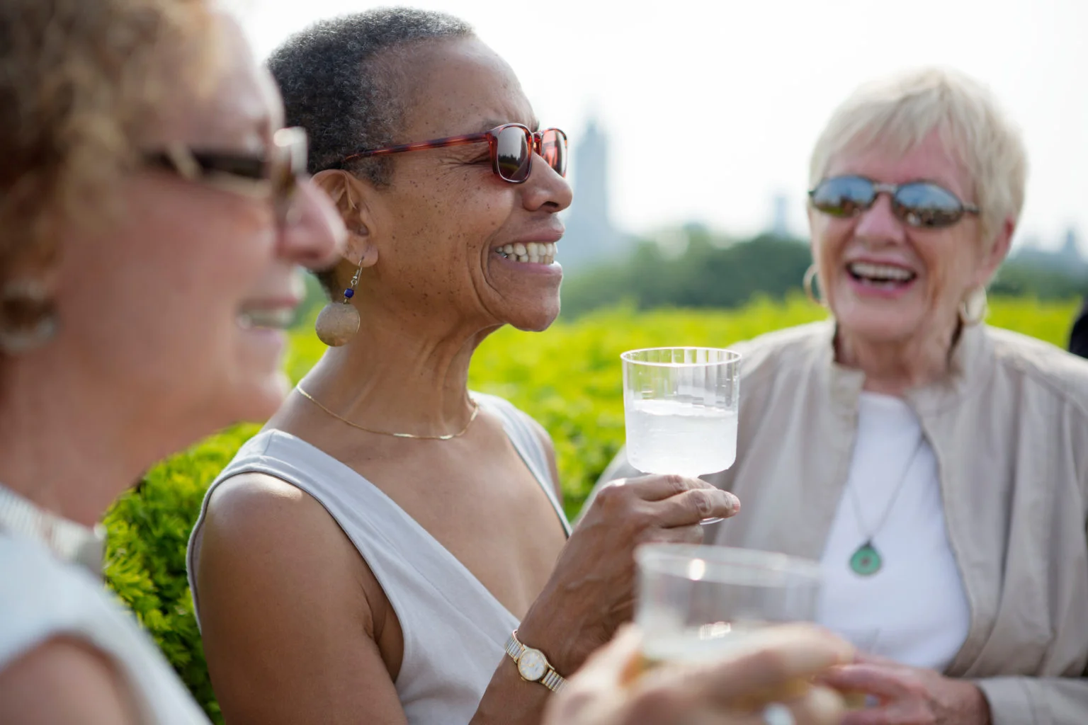Senior friends having drink outside