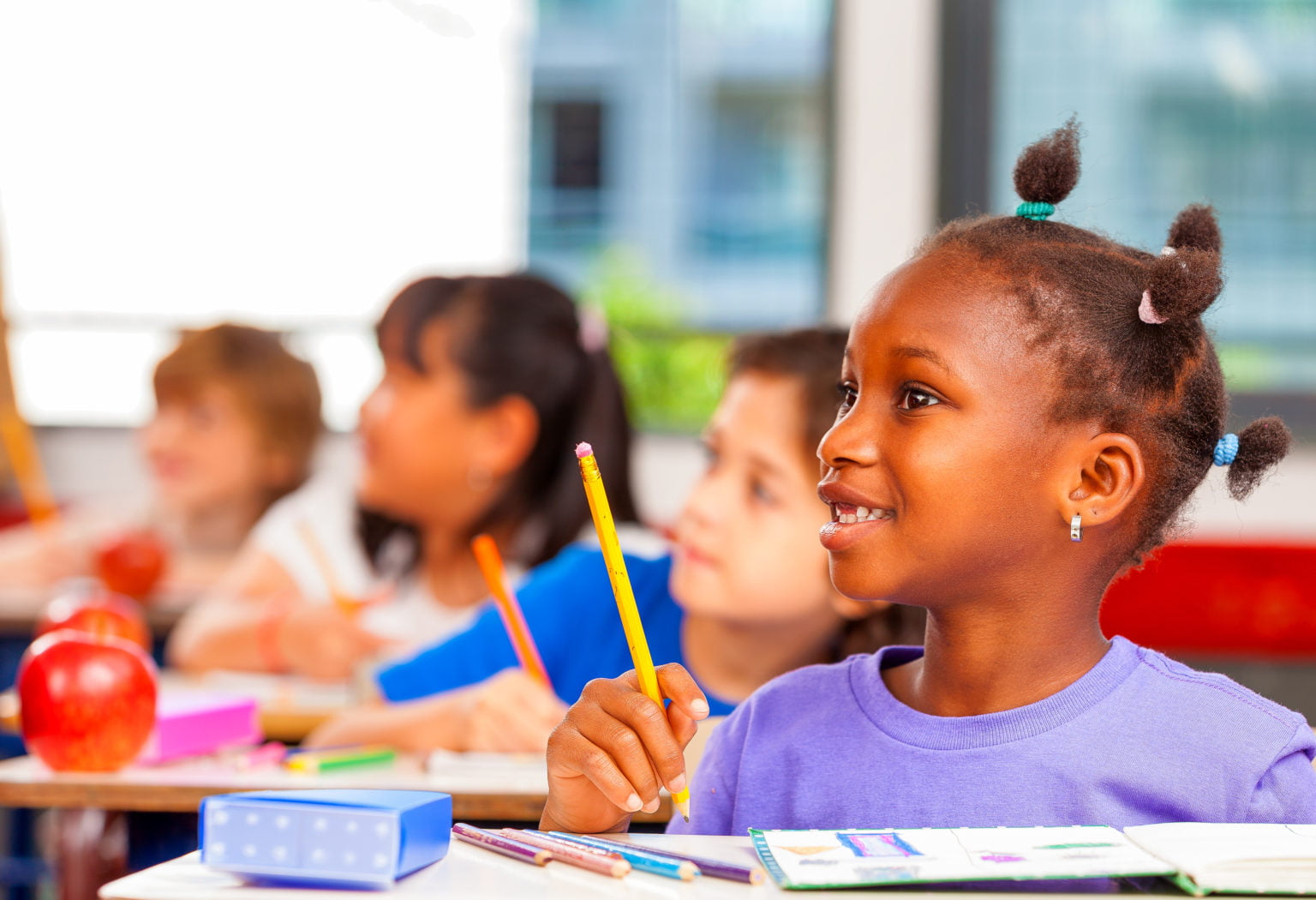 Happy children in a multi ethnic elementary classroom