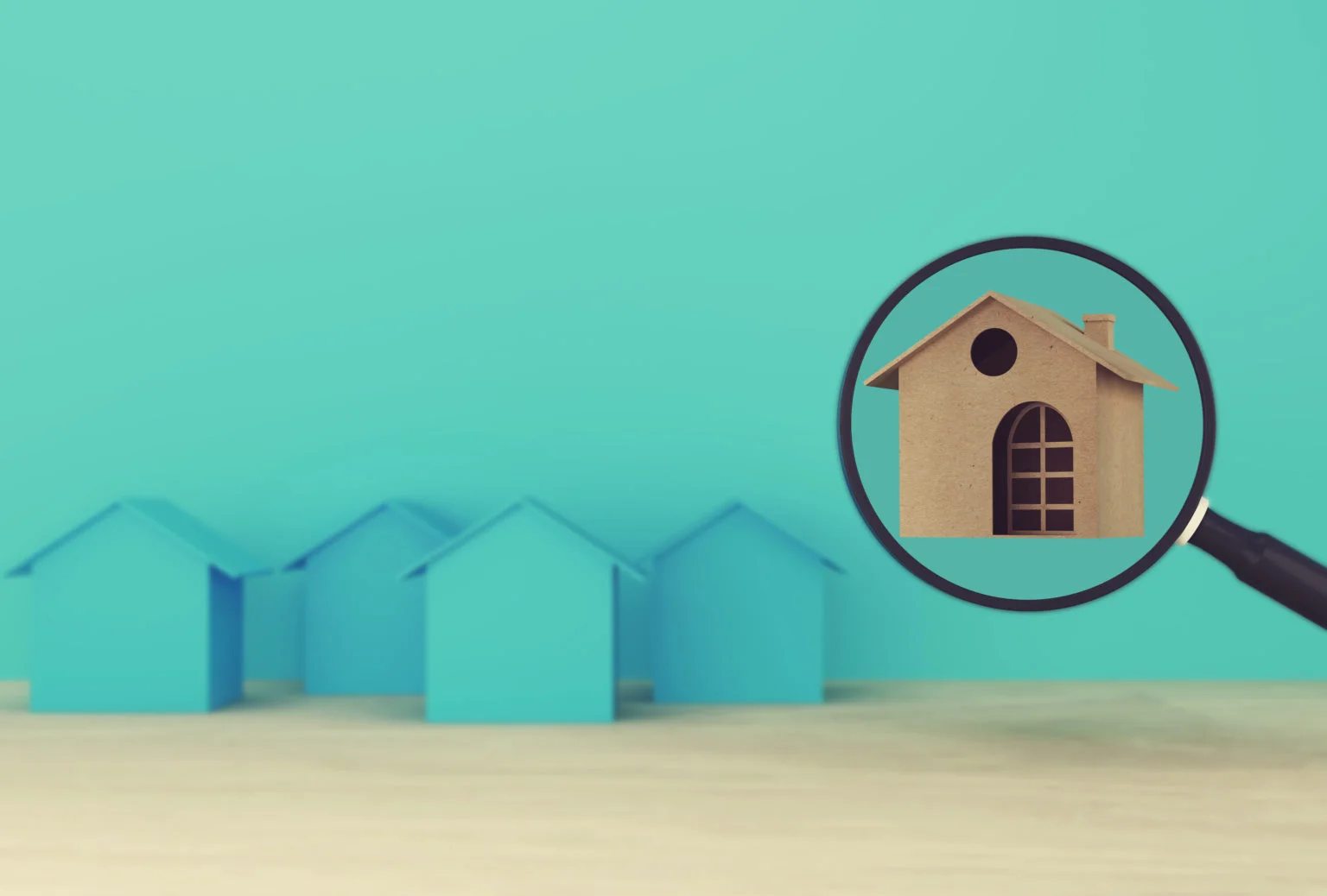 Model house in a magnifying glass