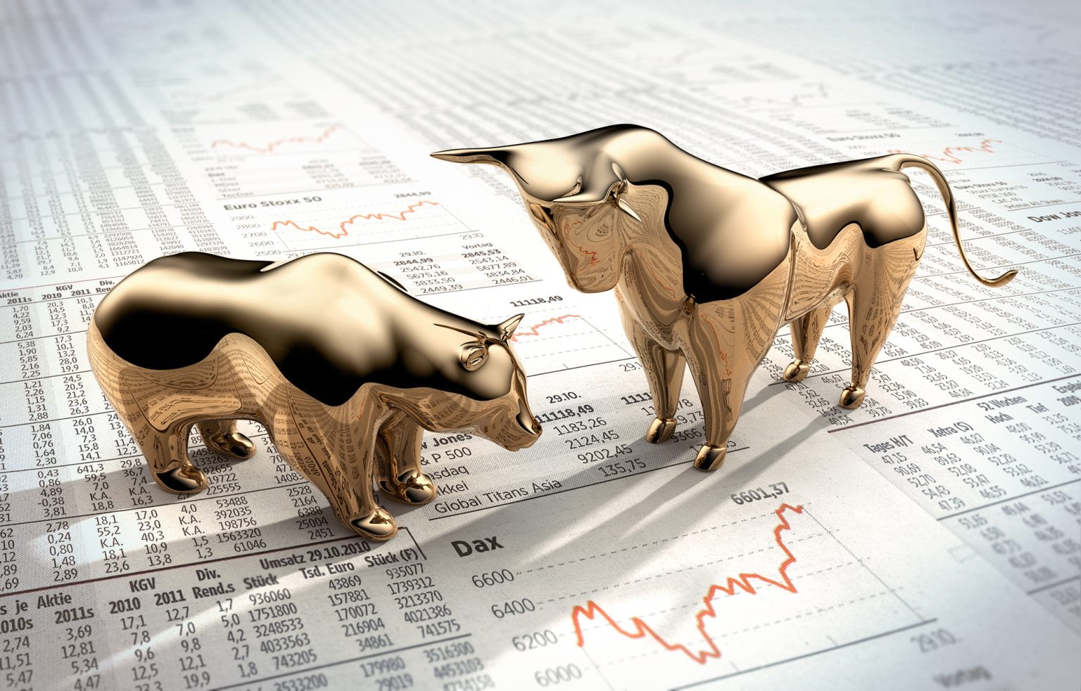 Gold bear and bull on a newspaper showing stock prices