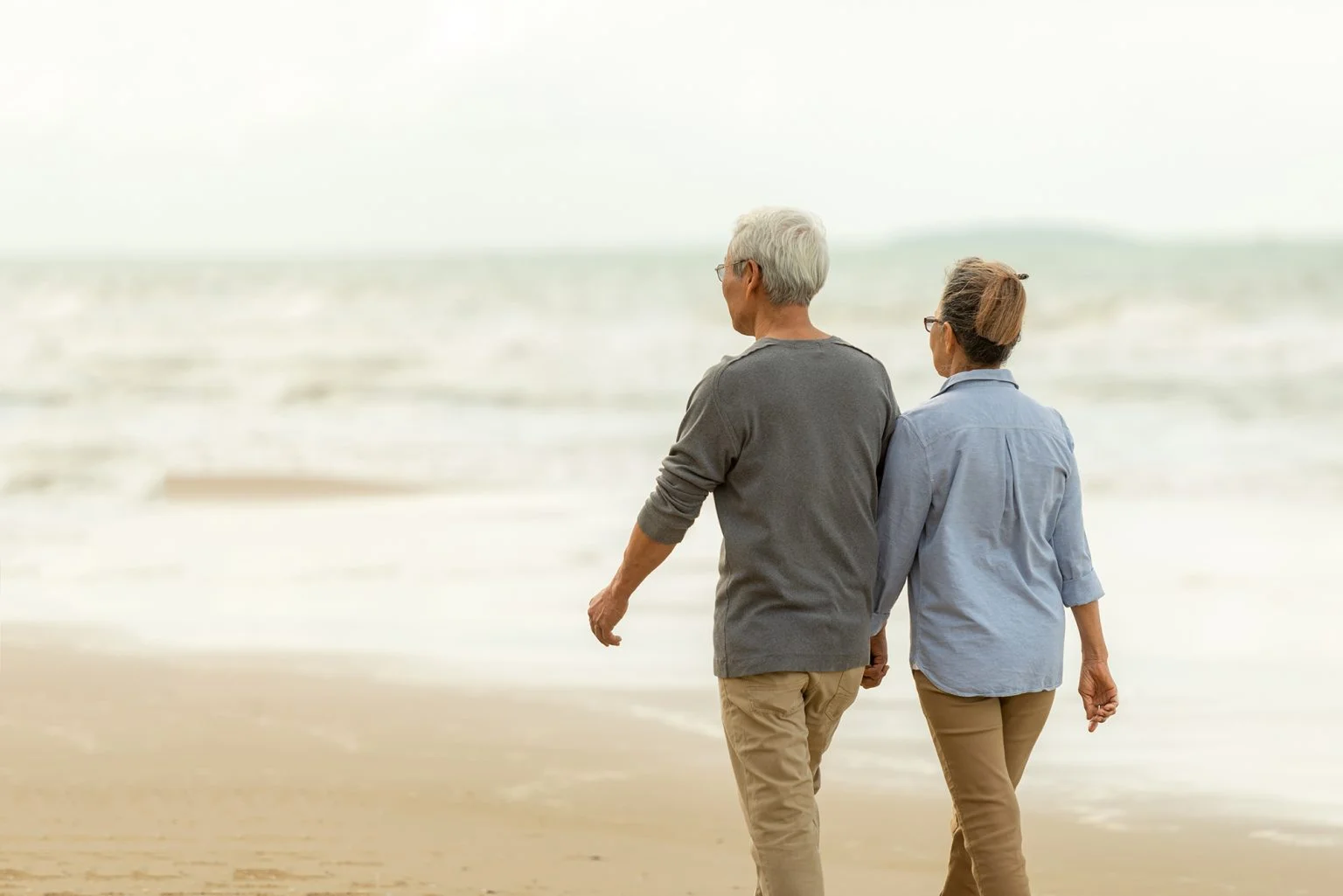 Senior couple walking on the beach