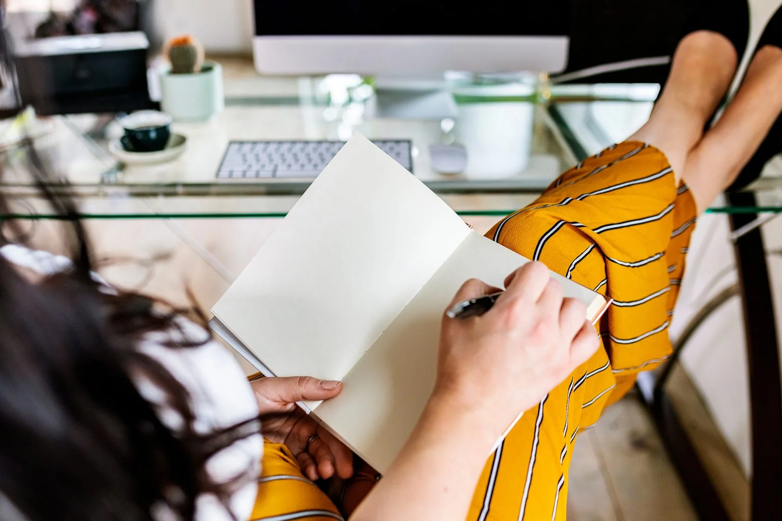 Woman sitting with her legs up on a desk