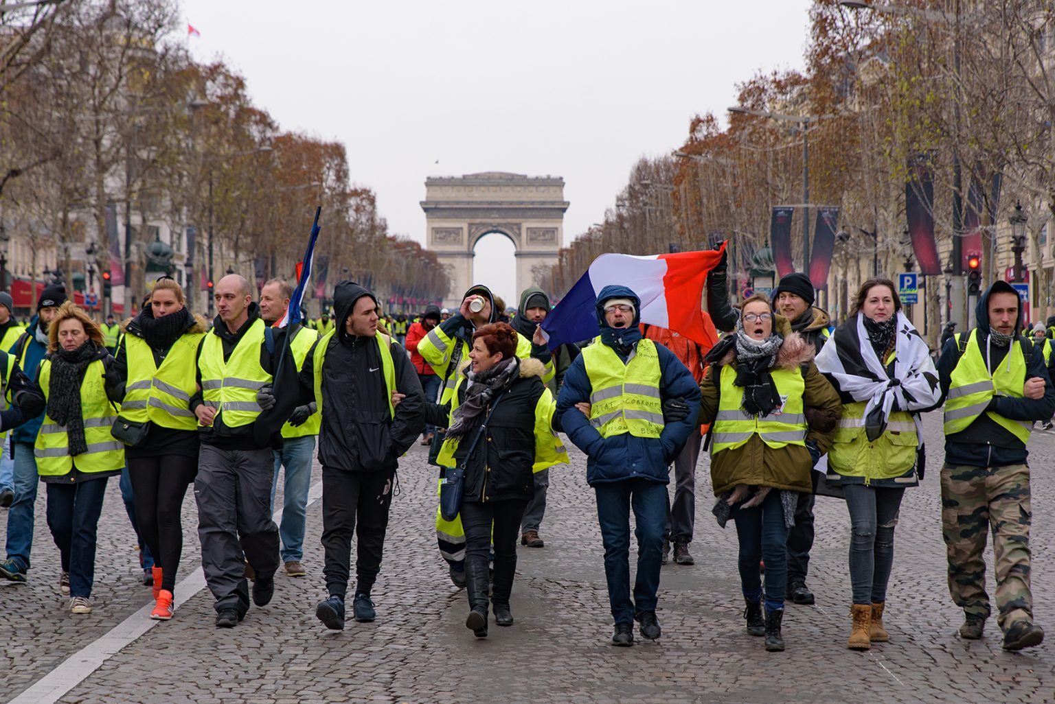 Yellow Vests demonstration (Gilets Jaunes) protesters against fuel tax, government, and French President Macron at Champs-Élysées and Arc de Triomphe