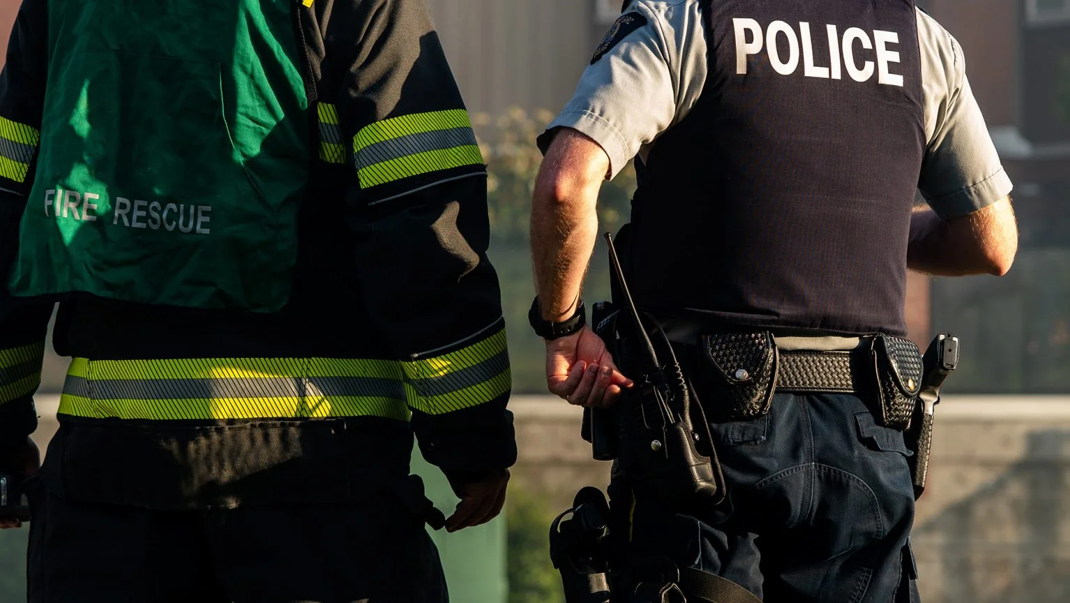 Back view of a firefighter and a police officer
