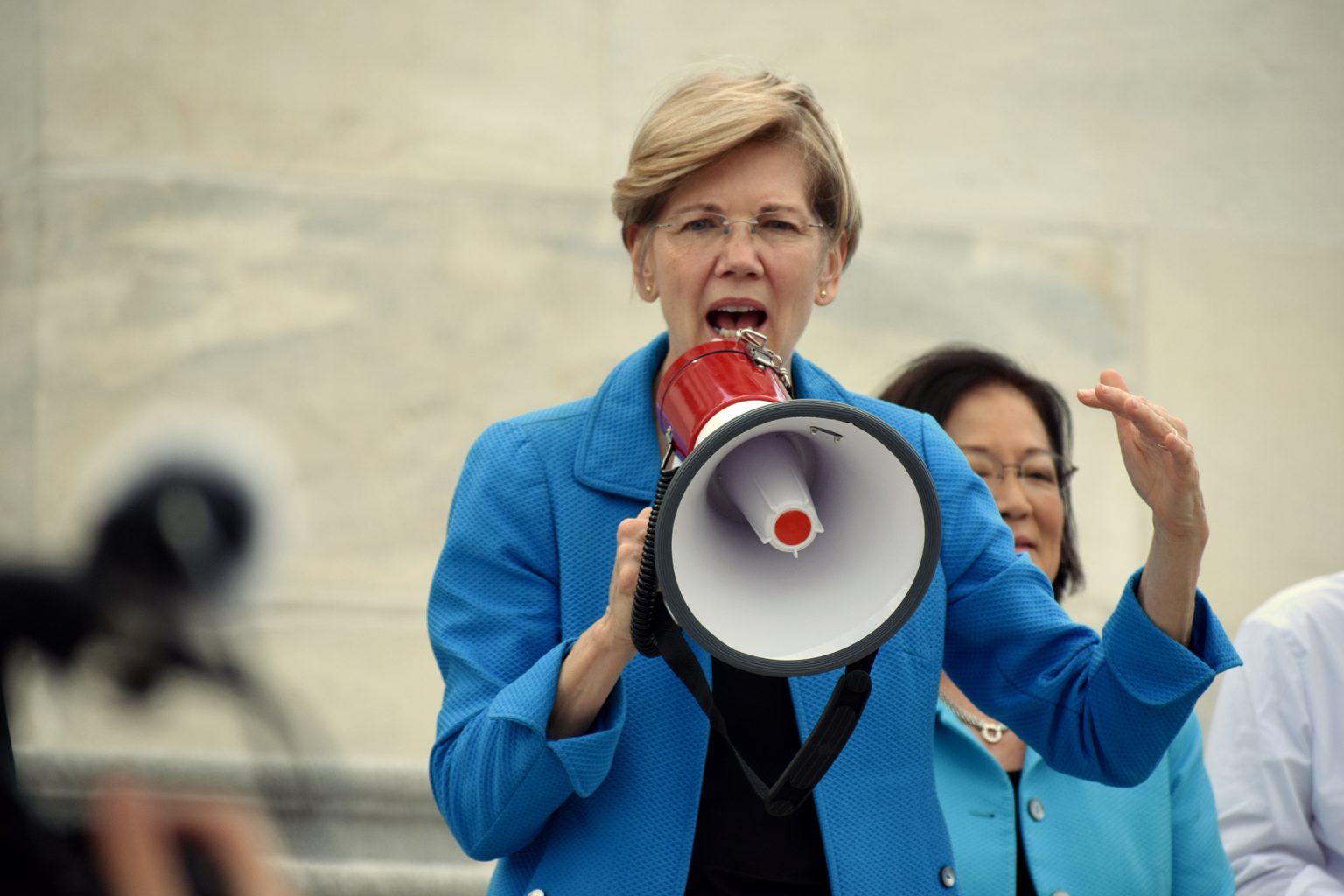 Senator Elizabeth Warren addresses crowds with a megaphone outside the Capitol
