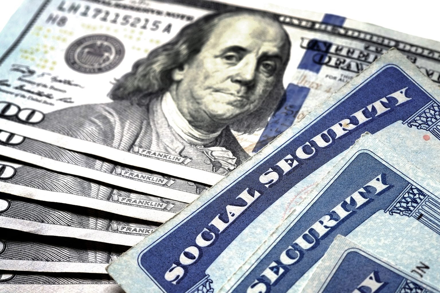 Social Security cards on top of U.S. currency