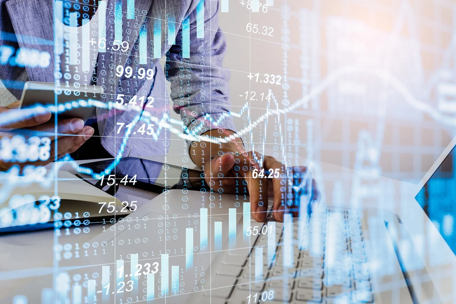 Stock market or forex trading graph and candlestick chart over person's hand working on a laptop