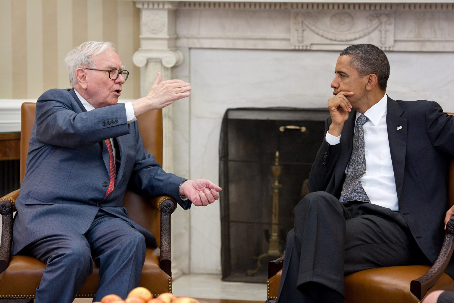 Warren Buffett sitting with President Barack Obama at the White House in July 2011