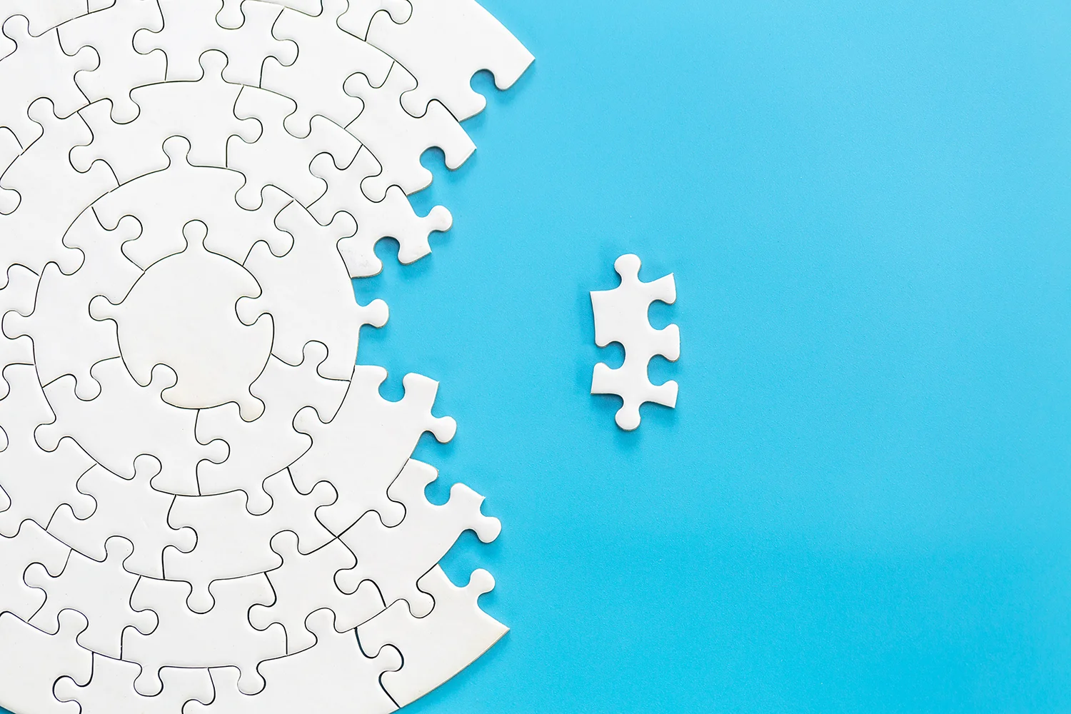 White jigsaw puzzle pieces on a blue background